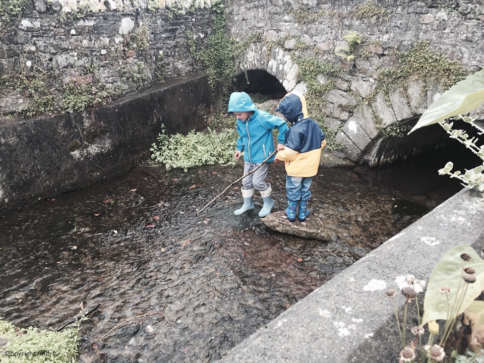 While waiting for the rain to clear up Max & Mathew played in the river.
